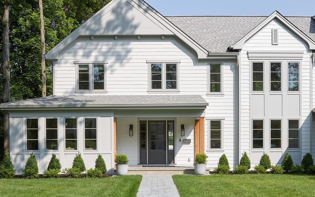 The same Westfield, NJ home built, photographed from the front walk, with the entry porch, cedar posts and gabled wings as drawn
