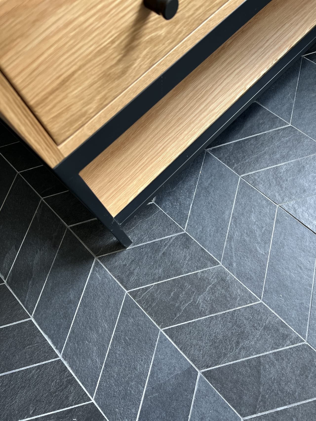 Charcoal chevron floor tile under a white oak vanity in a Westfield, NJ bathroom by Michael Robert Construction