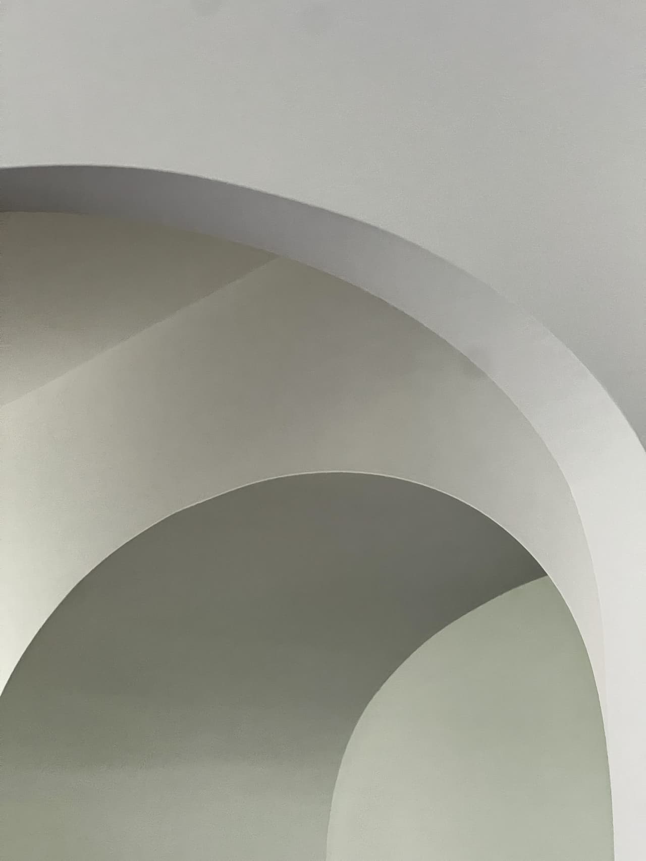 Two plaster arches nested one behind the other in a Westfield, NJ home by Michael Robert Construction