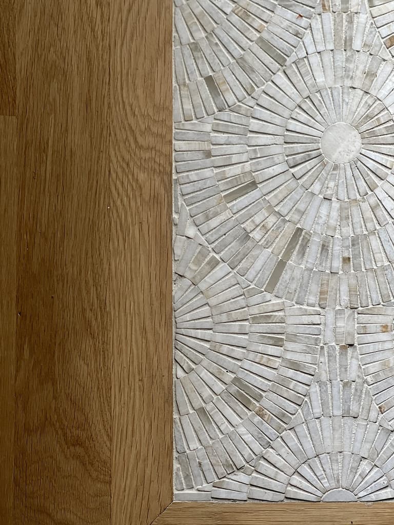 Mother-of-pearl mosaic medallion inset into a white oak floor with a mitered border at a Westfield, NJ renovation and addition by Michael Robert Construction