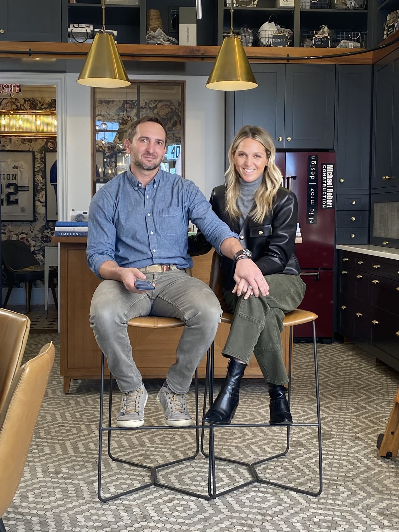 Mike and Ellie Mroz in 2024, on stools in the shared Michael Robert Construction and Ellie Mroz Design studio on West Broad Street in Westfield, NJ