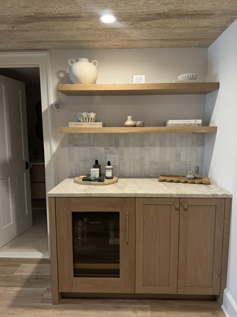 Built-in oak kitchenette and water station with a marble counter in a Short Hills, NJ basement by MRC