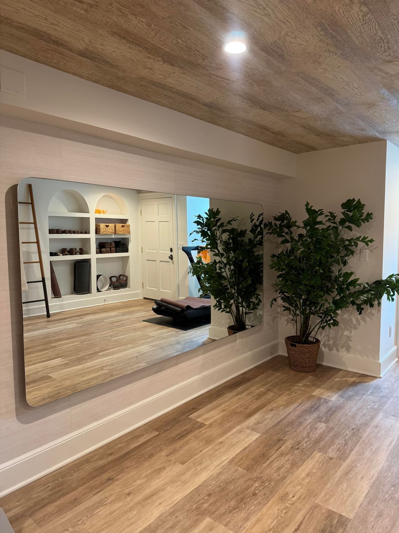 Mirrored wall and arched built-ins in a Short Hills, NJ basement yoga studio by Michael Robert Construction