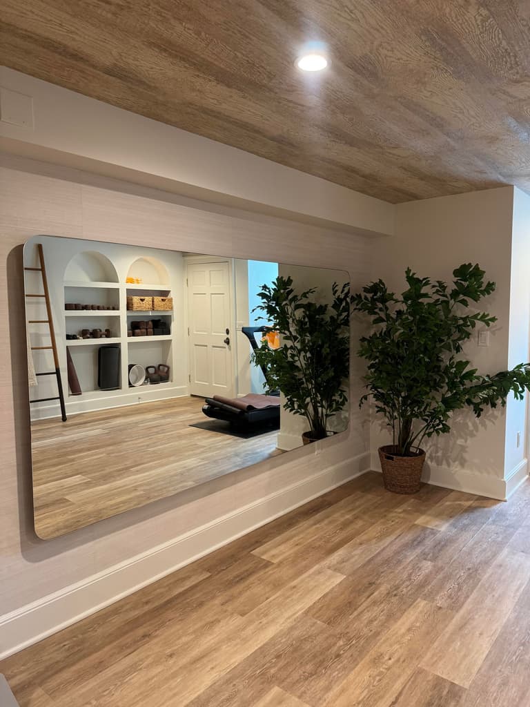 Mirrored wall and arched built-ins in a Short Hills, NJ basement yoga studio by Michael Robert Construction
