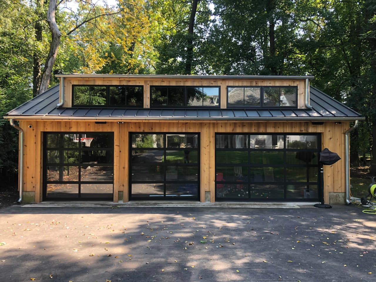 Detached garage in cedar and black steel with glazed carriage doors and a clerestory above, in Westfield, NJ