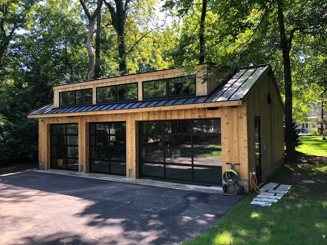 Cedar and glass garden structure with folding glass doors and a standing-seam roof at the back of a Westfield, NJ property