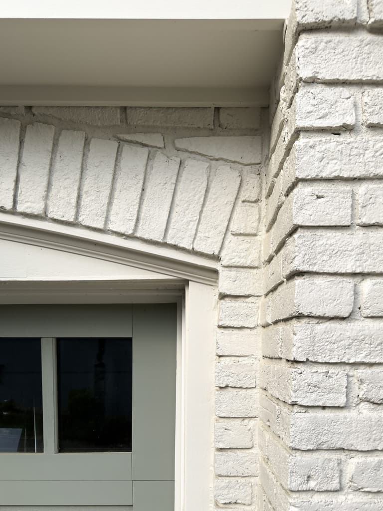 Soldier-course brick arch over a window head in the painted brick of a Mountainside, NJ exterior renovation by Michael Robert Construction