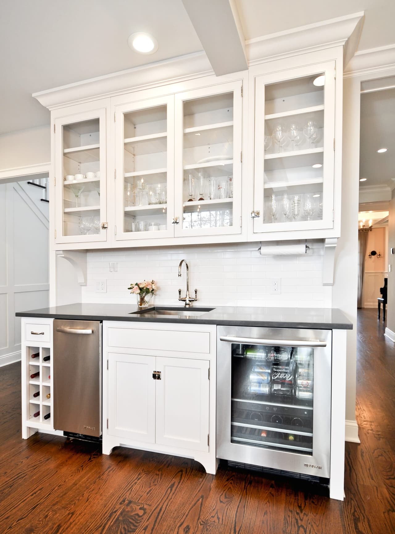 Butler's pantry with glass-front uppers, a dark counter, a prep sink and an undercounter wine refrigerator