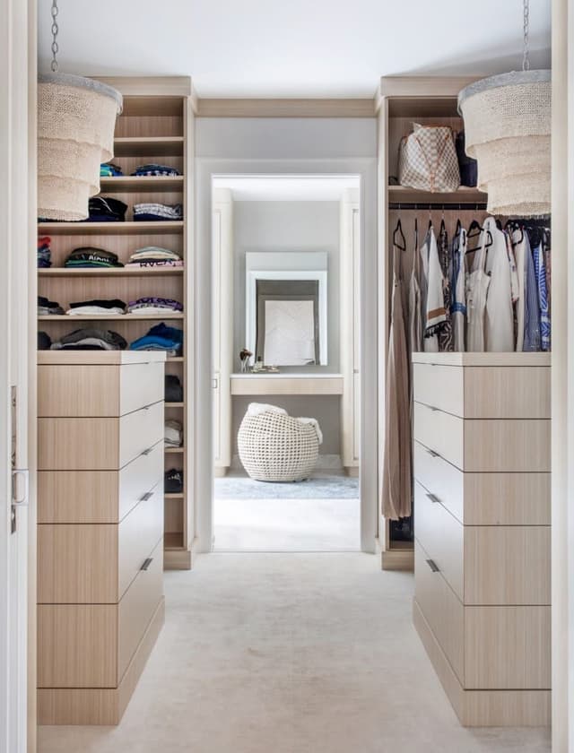 Fitted dressing room in a Westfield, NJ home, with pale oak drawers and hanging either side and a mirror at the end