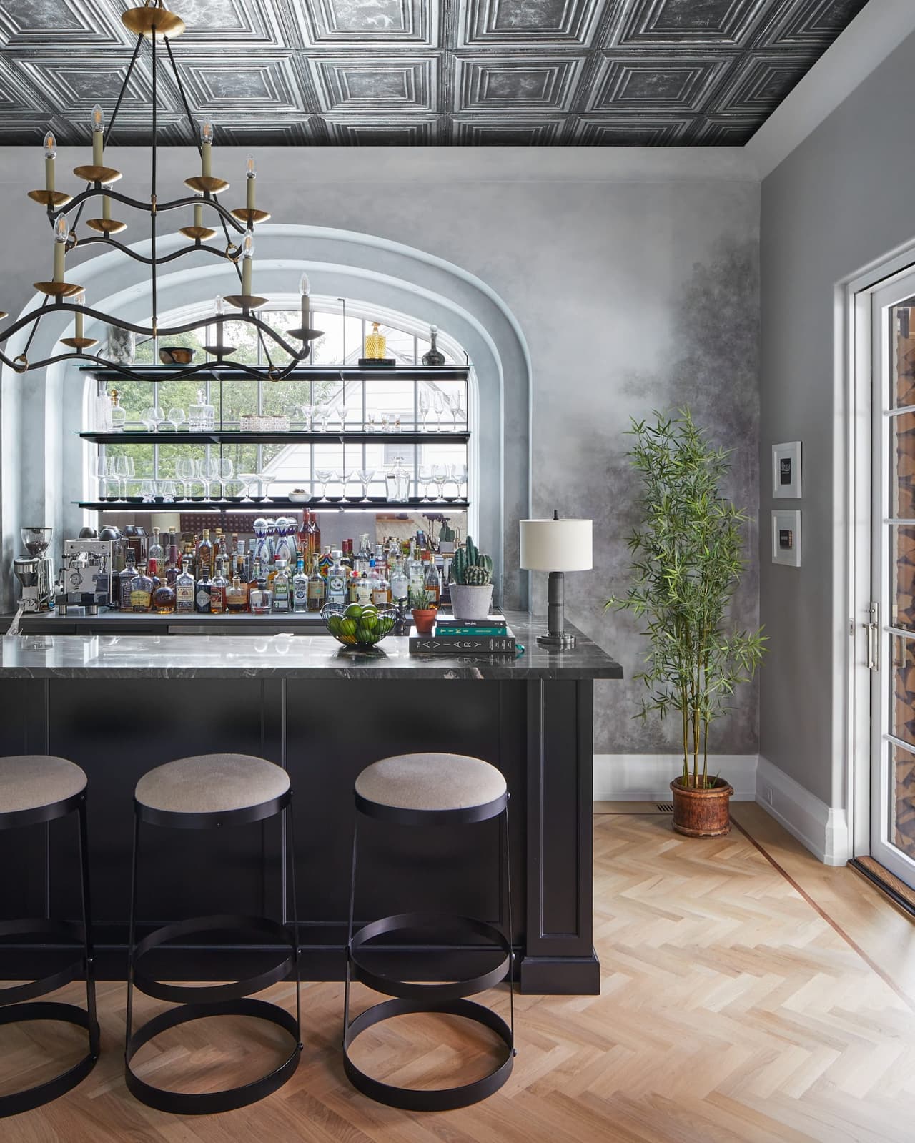 Pub in a Westfield, NJ custom home, with an antiqued tin ceiling, an arched bar back, a custom mural and leather stools