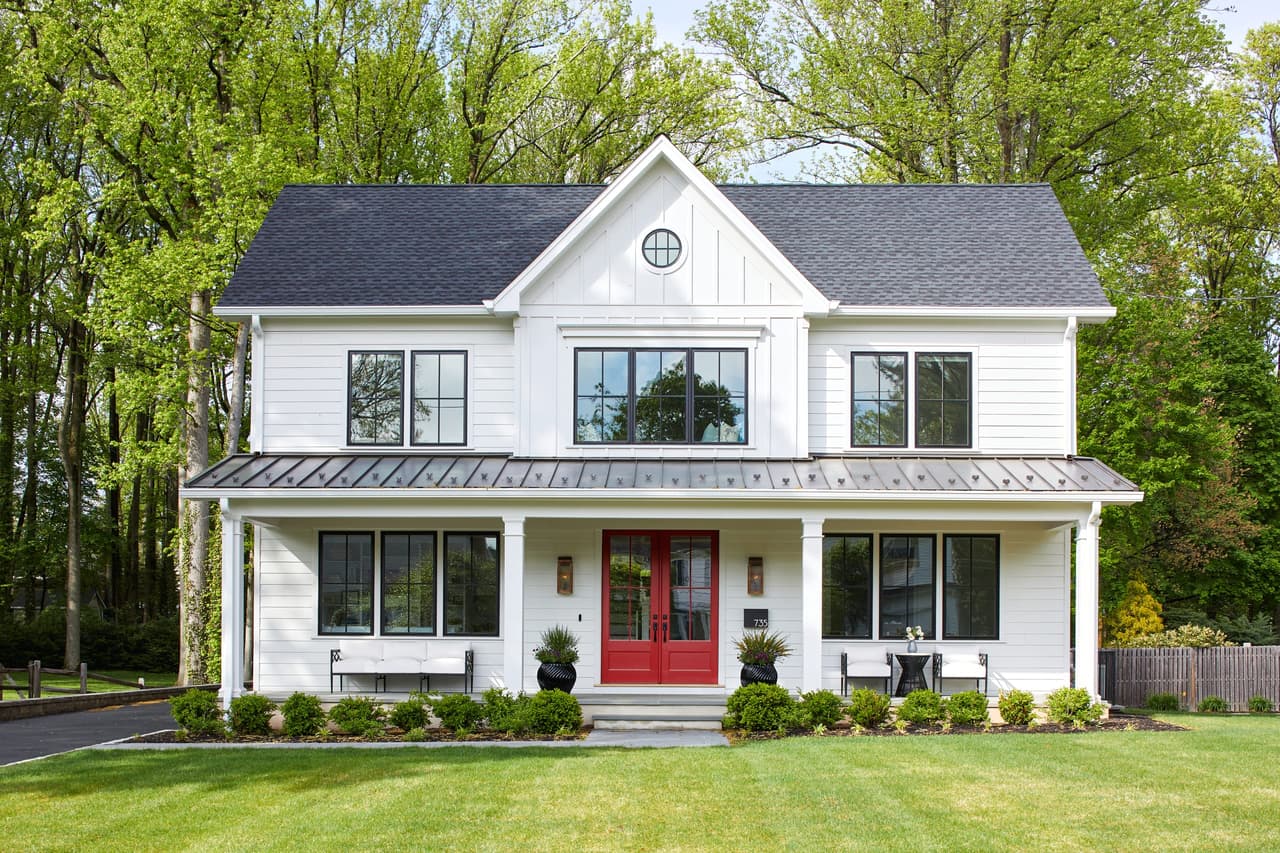 Modern farmhouse custom home with a red front door and covered porch in Westfield, NJ, built by Michael Robert Construction