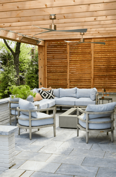 Covered outdoor room with a slatted cedar screen wall, a planked ceiling and cushioned seating