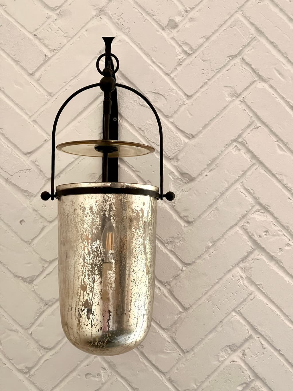 Mercury glass bell lantern hung against a whitewashed herringbone brick wall in a Westfield, NJ mudroom renovation
