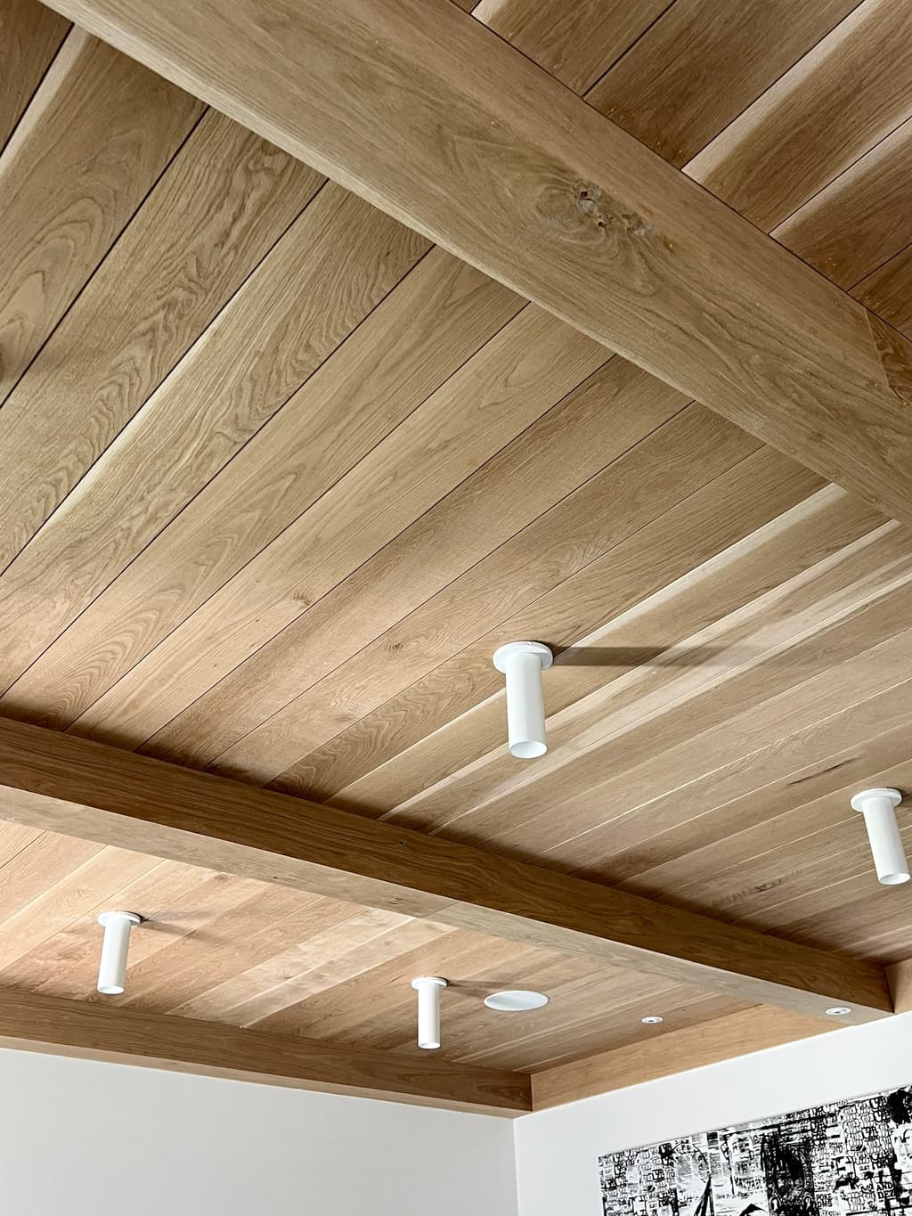 Planked cedar ceiling on painted beams, seen from below, in the family room of a Westfield, NJ renovation