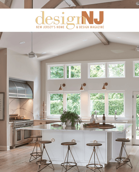 Design NJ masthead above a vaulted white kitchen with exposed beams and tall windows, from its coverage of Michael Robert Construction