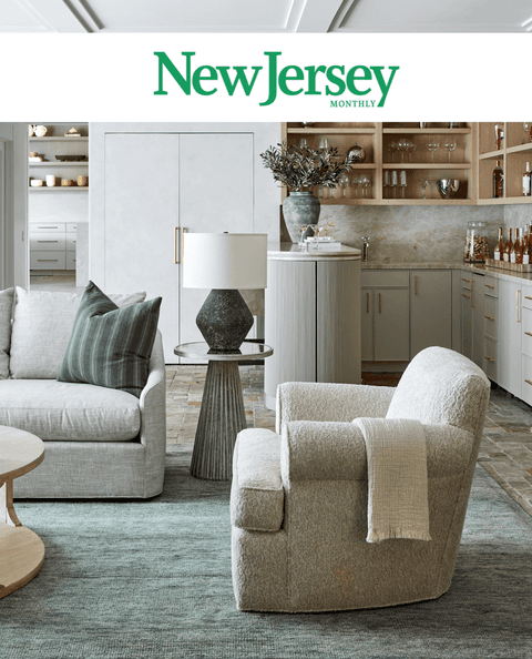 New Jersey Monthly masthead above a pale living room with swivel chairs and a sage rug, from its coverage of Michael Robert Construction