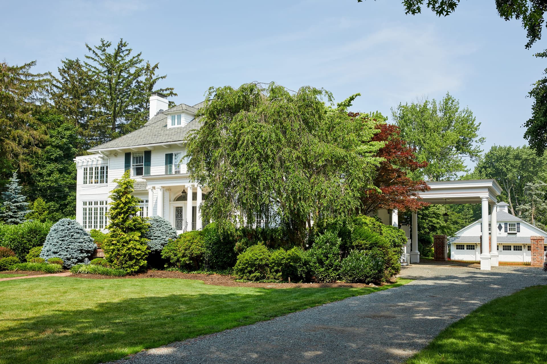 Classic white historic home with a new carport after renovation in Westfield, NJ