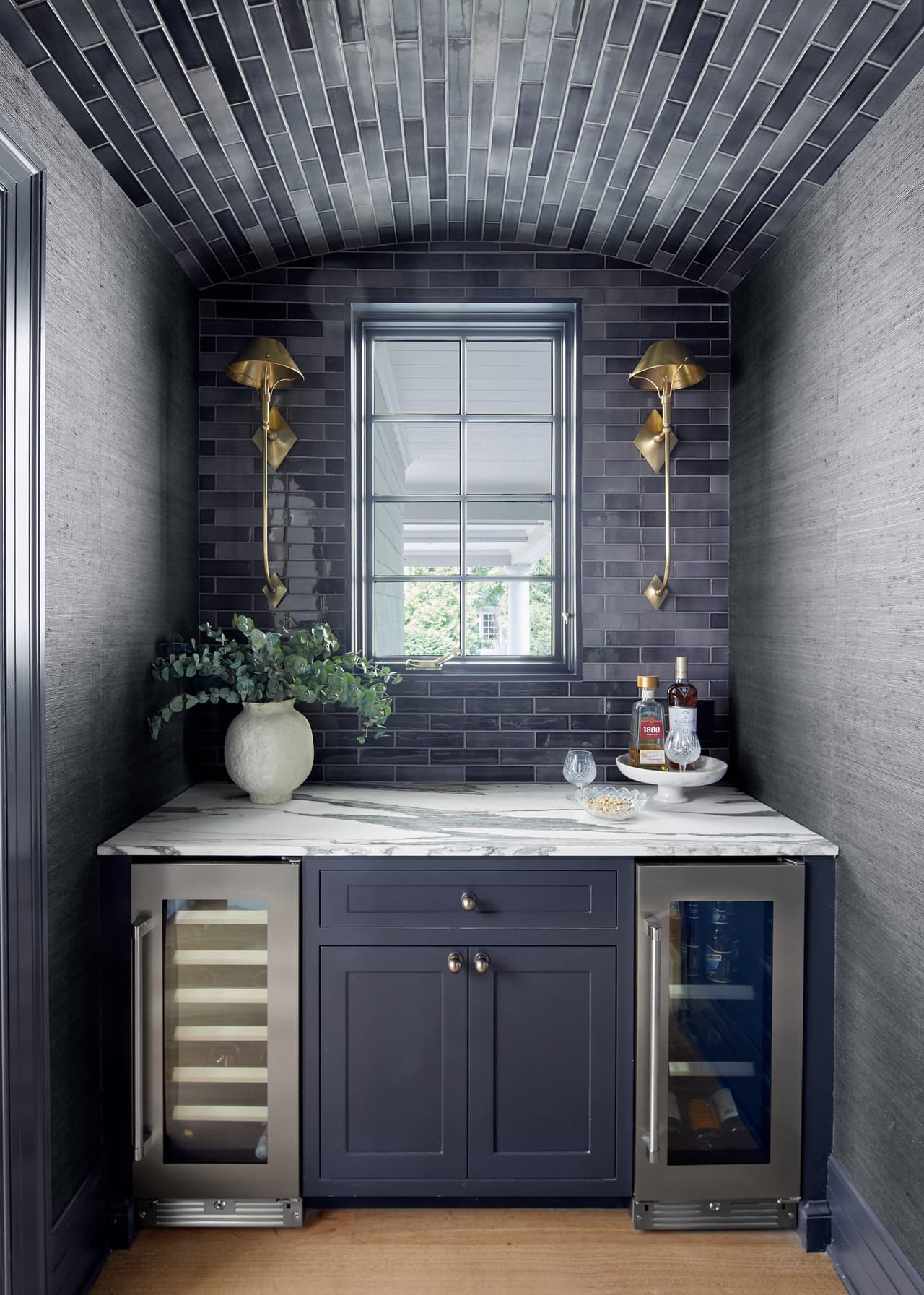 Navy butlers pantrybar with brass hardware and lights in a historic renovation in Westfield, NJ