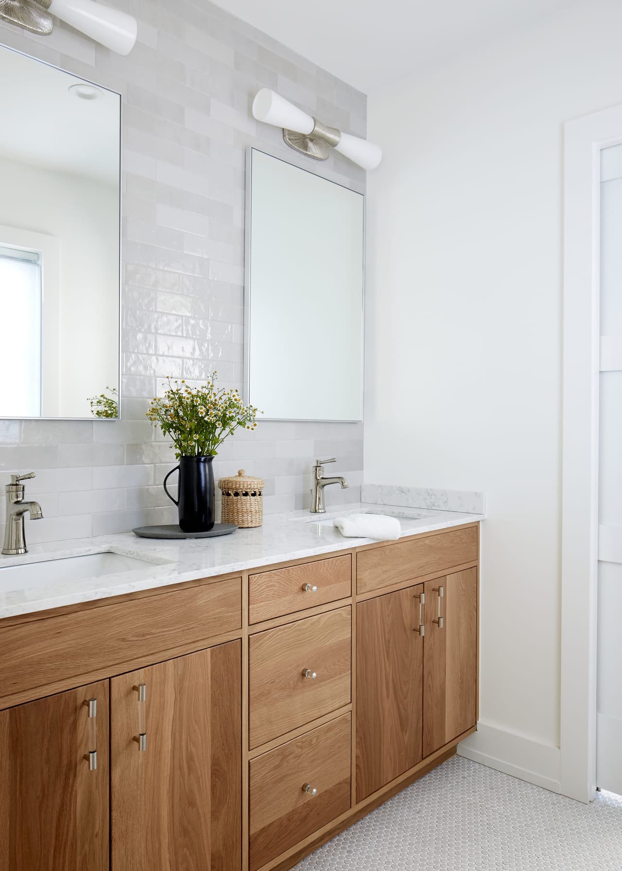 Double vanity in natural oak under a frameless mirror and linear light in a white Westfield, NJ bathroom renovation