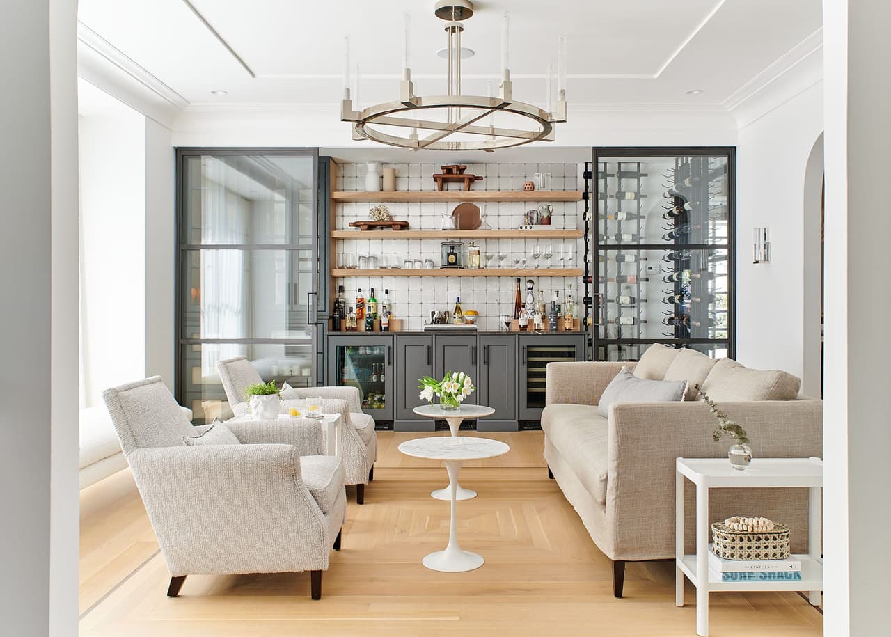 Sitting room of the Mroz family home in Westfield, NJ, looking through a black steel partition to the bar and wine wall beyond
