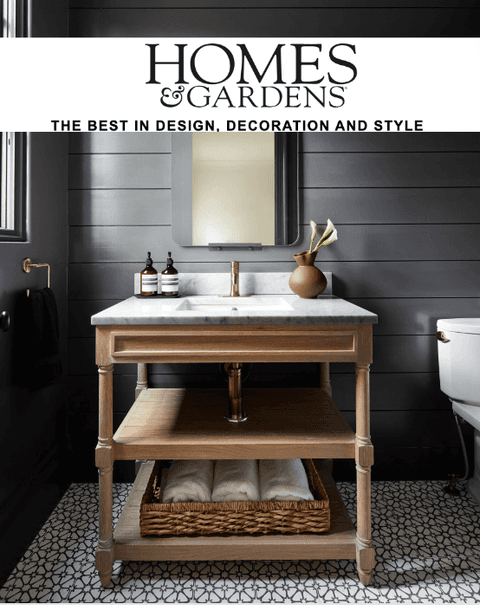 Homes & Gardens masthead above a bathroom with black shiplap and an oak washstand, from its coverage of Michael Robert Construction