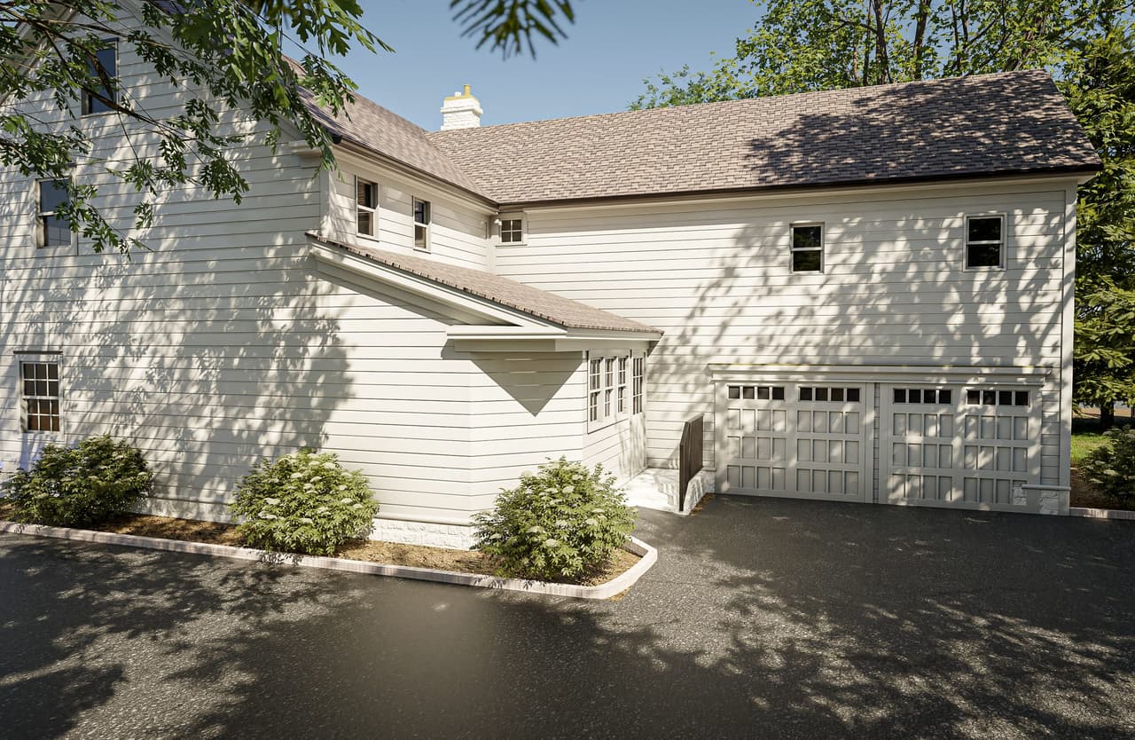 Architectural rendering of a Summit, NJ home from the drive, with a garage under the house, a gabled roof and a planted bed along the turning circle