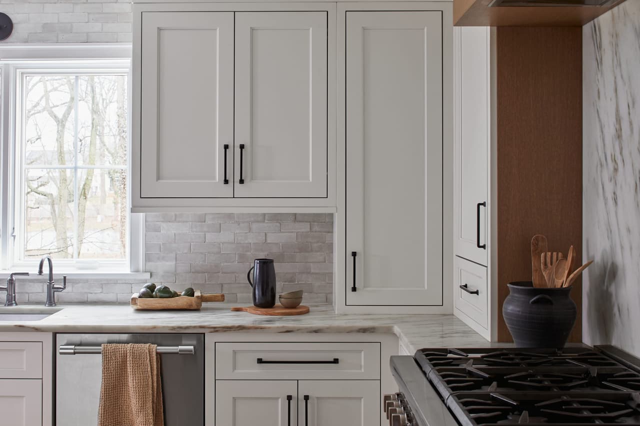 White kitchen with zellige tile, marble counters and oak accents in a Westfield, NJ home renovation and addition by Michael Robert Construction