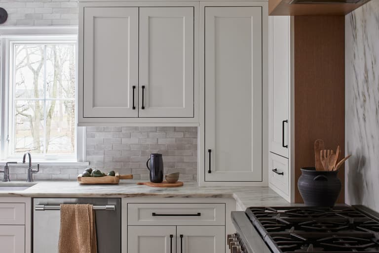 White kitchen with zellige tile, marble counters and oak accents in a Westfield, NJ home renovation and addition by Michael Robert Construction