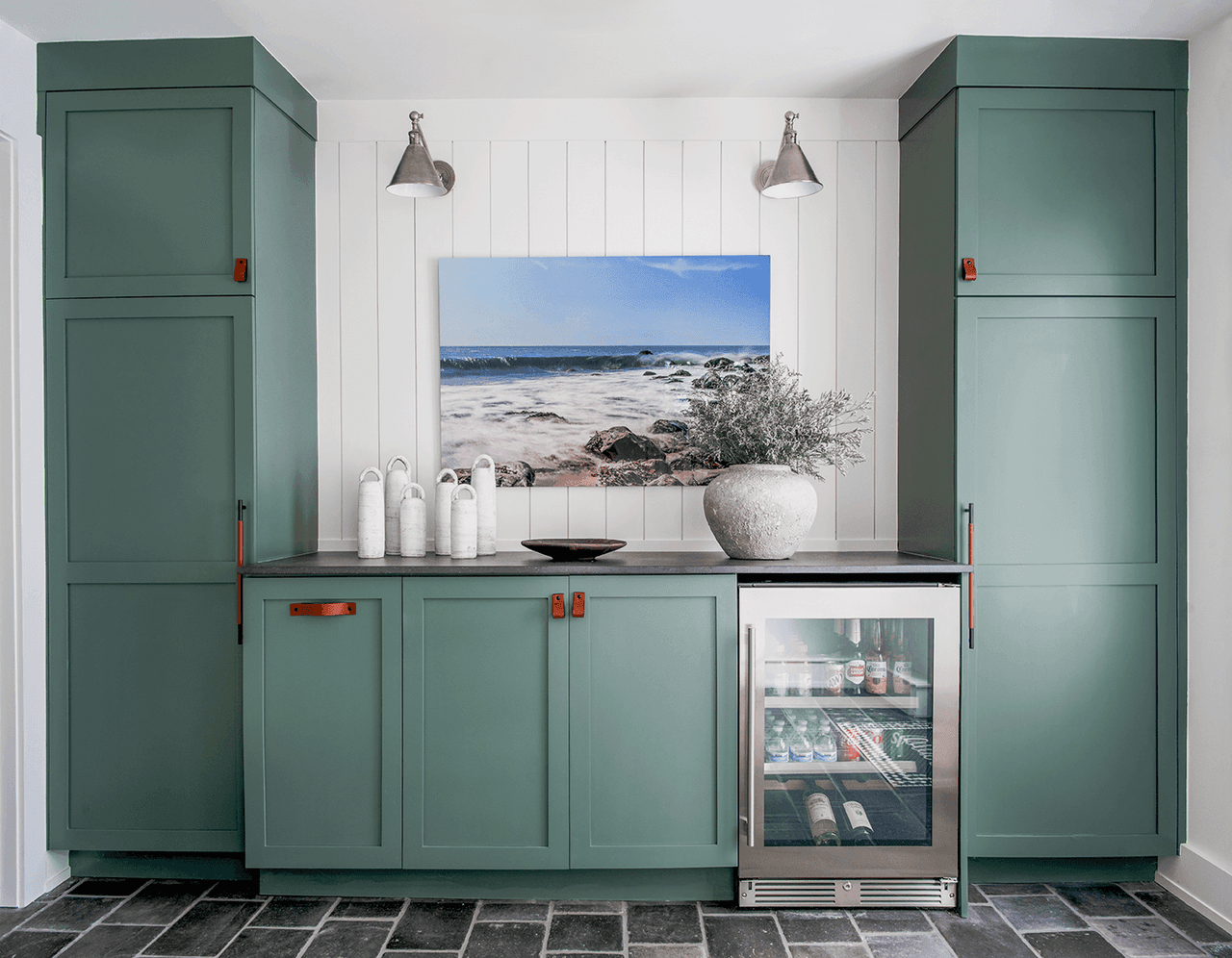 Entry and mudroom in a Westfield, NJ barn renovation, with sage cabinetry, a bench, a framed coastal picture and a slate floor