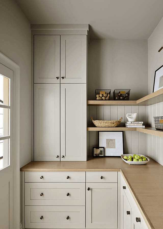 Walk-in pantry off a Mendham, NJ kitchen, with full-height cabinetry, open shelves above the counter and a window at the end