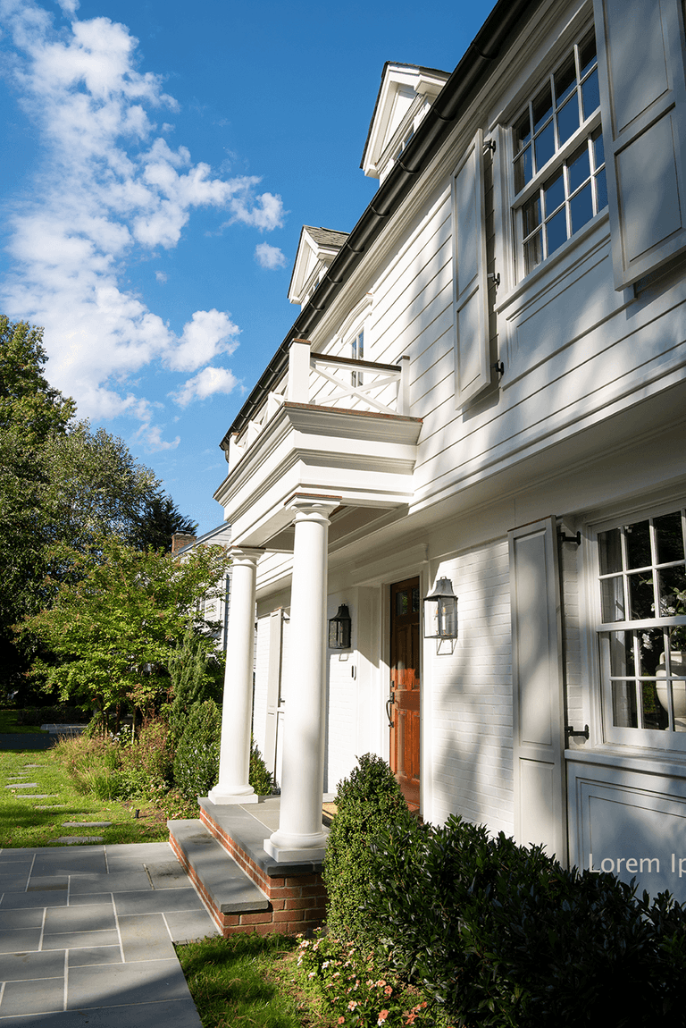 Side view along the portico of a Summit, NJ exterior renovation, showing the columns, the bluestone landing and the balustrade above