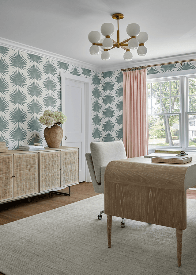 Home office in a Westfield, NJ new-construction home, papered in a green scallop print, with a cane-fronted credenza and a brass globe chandelier