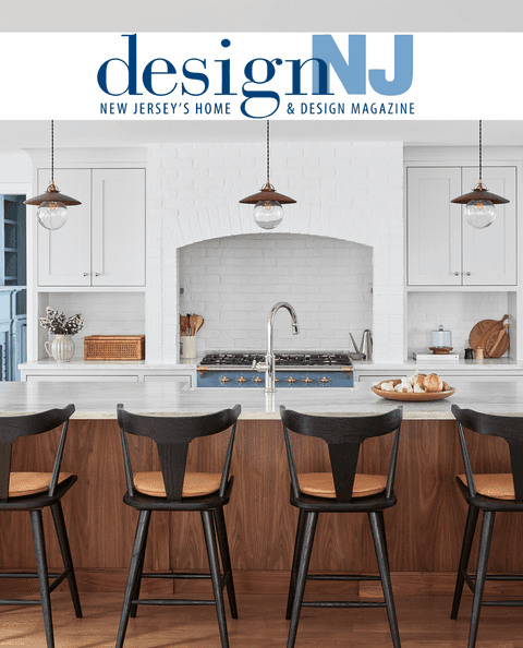 Design NJ masthead above a white kitchen with a plaster hood and a walnut island, from its coverage of Michael Robert Construction