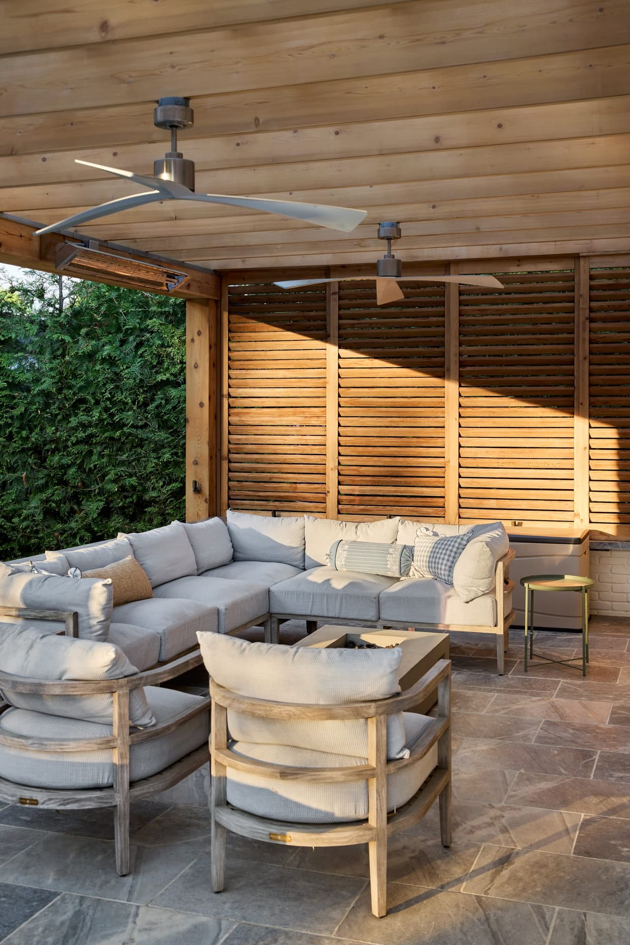 Covered pergola with a planked wood ceiling, a slatted screen wall and deep outdoor seating in Westfield, NJ