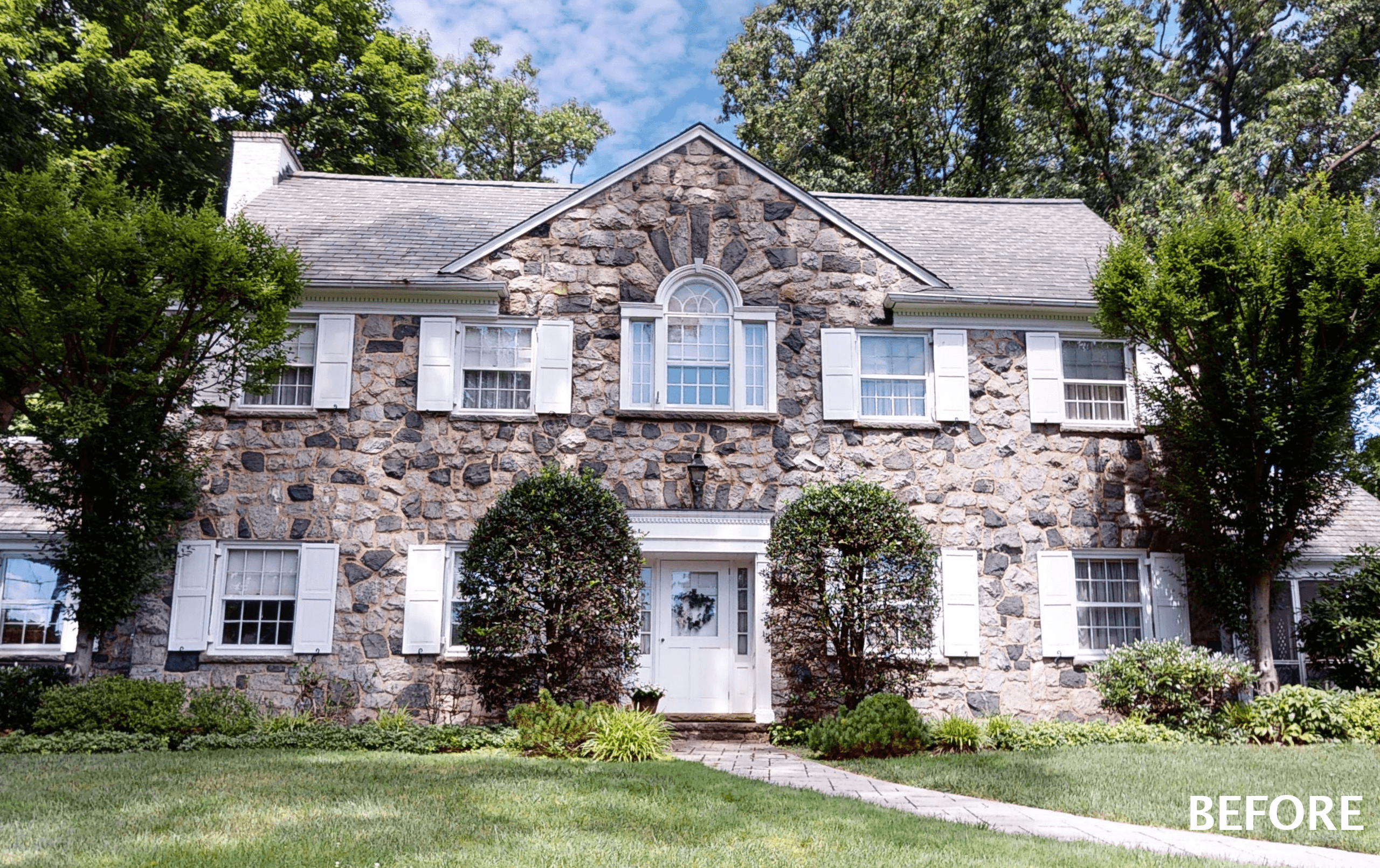 Before photograph of the existing stone home in Westfield, NJ, with clipped shrubs across the front, labeled Before in the corner