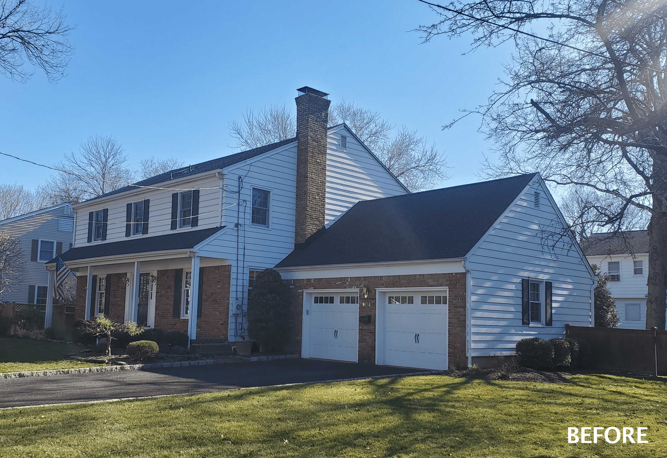 Before photograph of a white Westfield, NJ colonial with a brick chimney, an attached garage and a sloping lawn, labeled Before in the corner