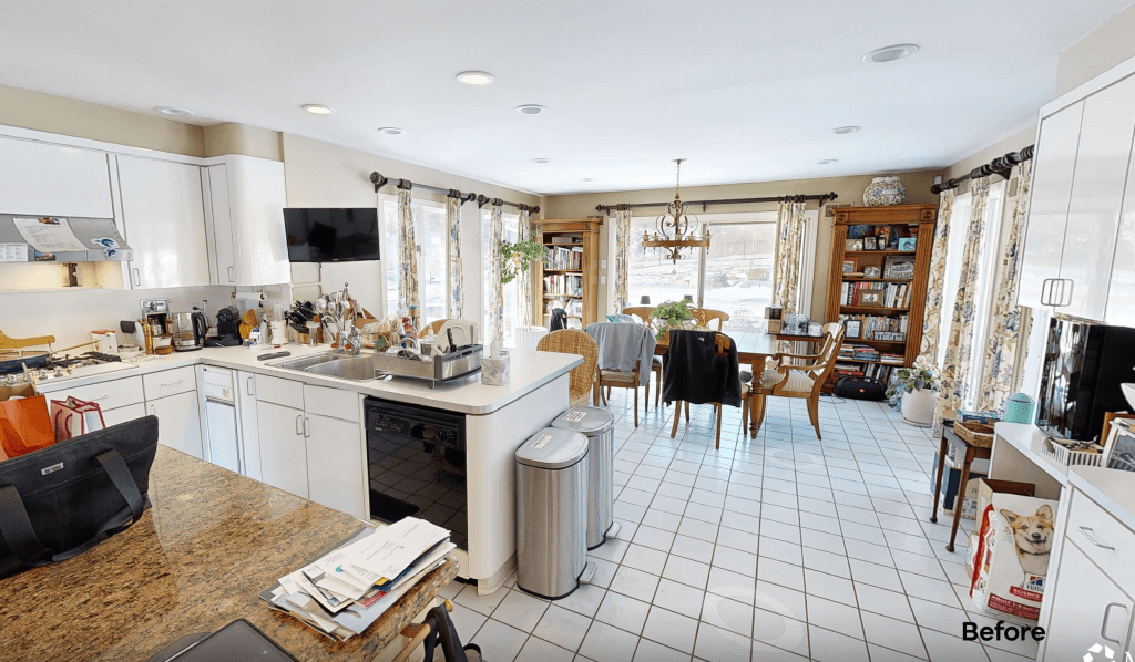 The kitchen before renovation, with a tiled floor, laminate counters and a cluttered island